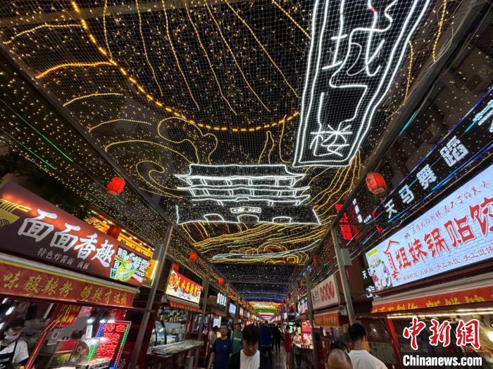 圖為明清街夜市燈光點(diǎn)亮具有武威文化元素的“涼州古城門”彩燈?！〈魑牟?攝</p><p>